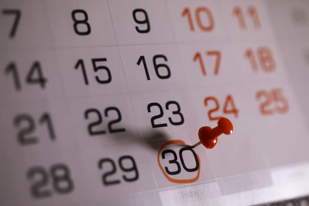 Calendar marked with 30-day deadline before wedding date for signing international prenuptial agreement to avoid pressure concerns
