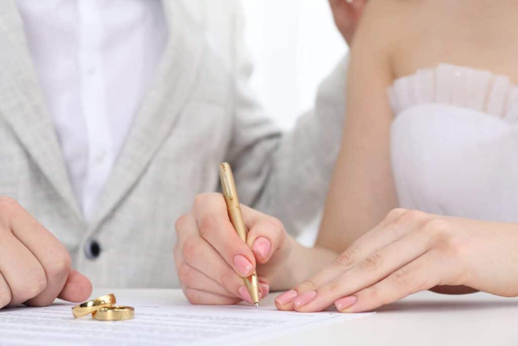 Couple signing prenuptial agreement with notary - legal prenup requirements