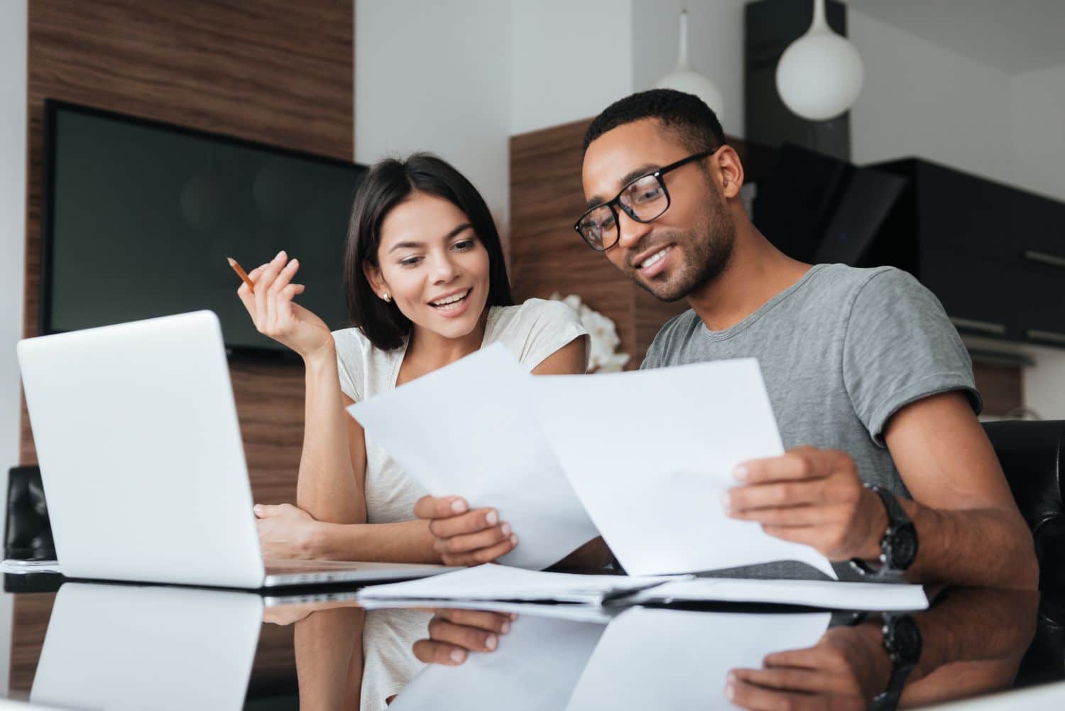 Young couple reviewing prenup alternatives and financial protection options on laptop at home